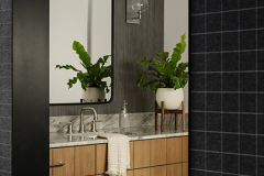 We built the cabinetry for the bathrooms; one features a kerfed oak, while another has a floating vanity.