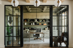 The office has a large wall of custom built-ins with a unique cerused oak finish.